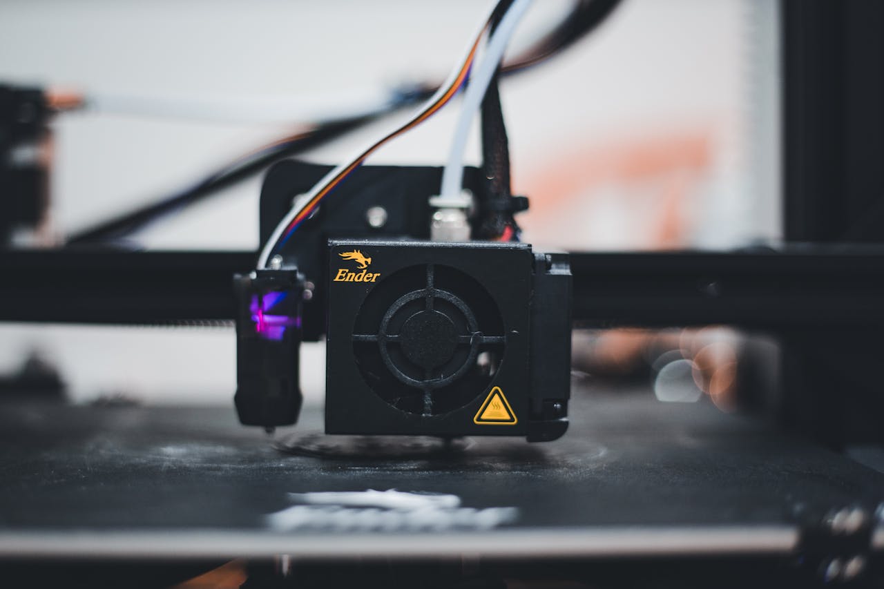 services-02 Detailed view of a 3D printer nozzle during the printing process, showcasing advanced technology.